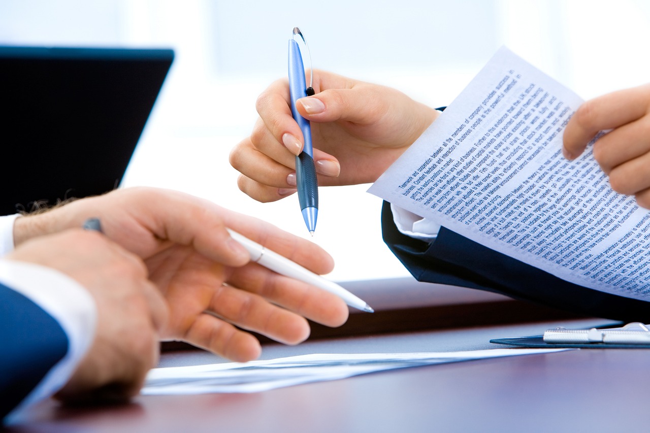 Couple reviewing real estate documents together at their kitchen table